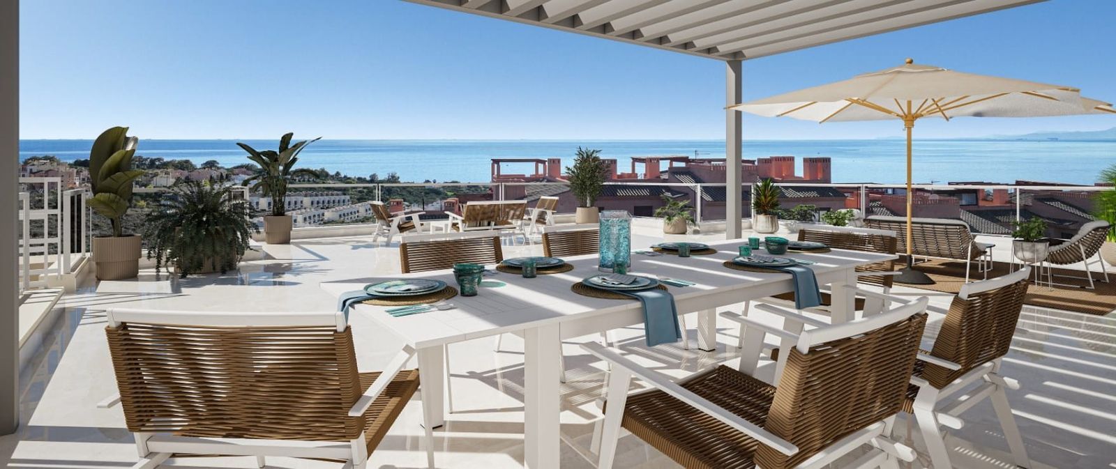 A spacious terrace with a dining table set for a meal and an expansive sea view.