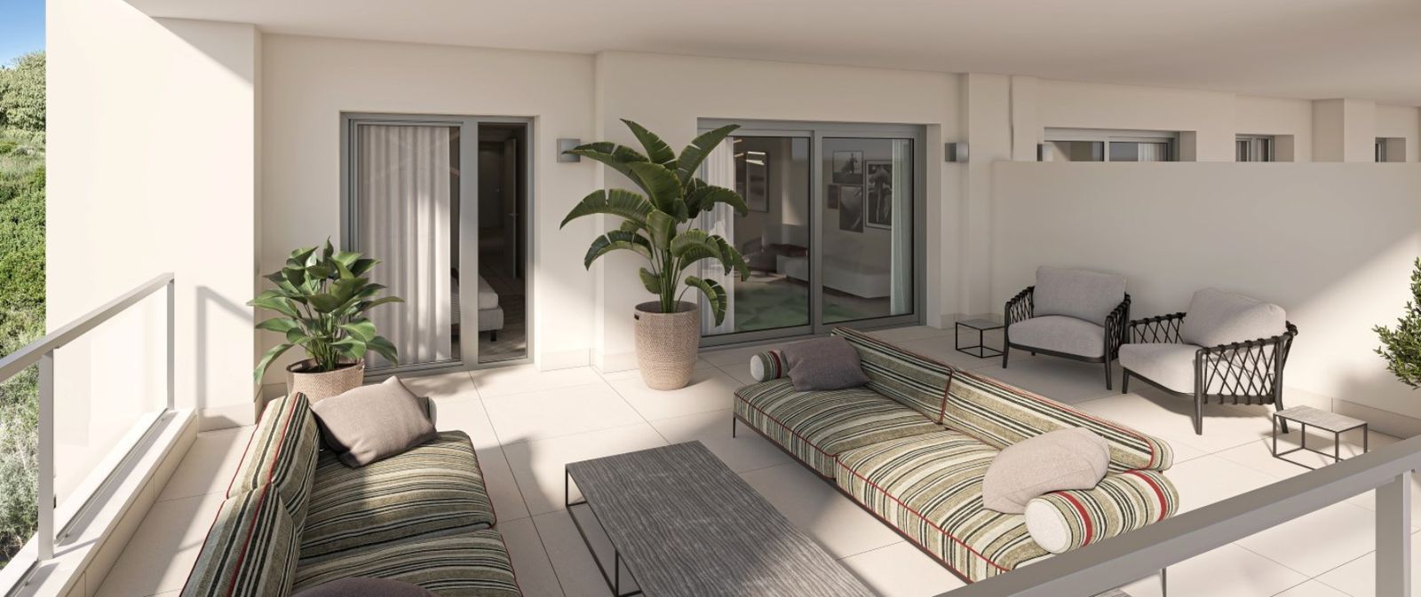Spacious balcony with modern outdoor furniture, including sofas, chairs, and coffee tables, offering a comfortable seating area.